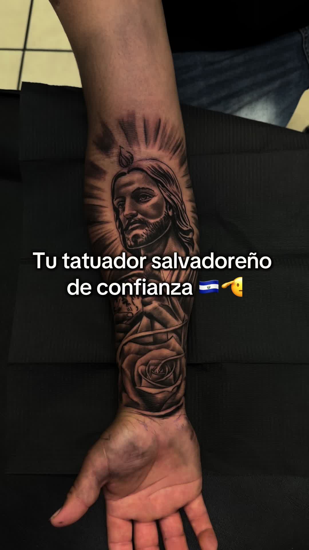 Tatuaje de San Judas Tadeo con una rosa en antebrazo, black and grey